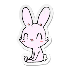distressed sticker of a cute cartoon rabbit sitting