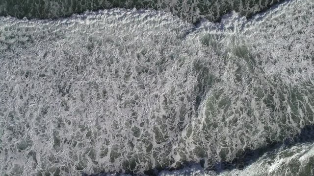 Aerial 4k nadir footage directly overhead of crashing blue, green white-capped waves at La Jolla, San Diego, California, USA