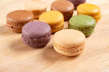 colorful macaroons on a wood background