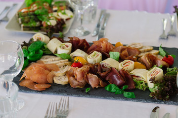 Fresh sliced meat on a white plate.