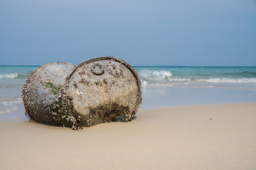 Old Tank with Sea barnacle on the beach with ocean blu sky background