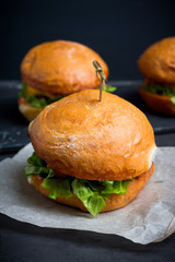 Tasty burger with fresh buns, meat and salad. Selective focus.