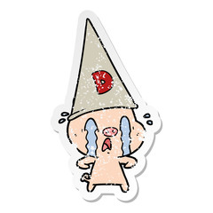 distressed sticker of a crying pig wearing dunce hat