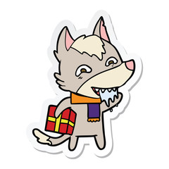sticker of a cartoon hungry wolf holding christmas present