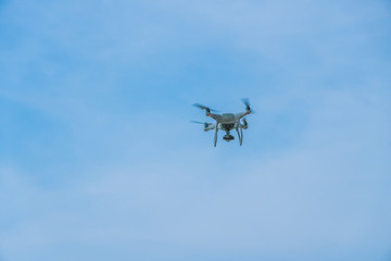 Fototapeta na wymiar flying drone with blue sky ocean island background