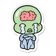 sticker of a cartoon big brain alien crying