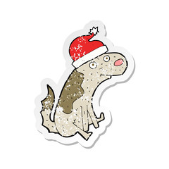 retro distressed sticker of a cartoon dog in christmas hat