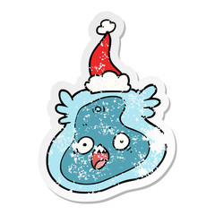 distressed sticker cartoon of a germ wearing santa hat