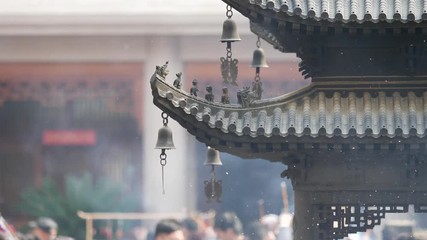 Immortal and beasts on the eaves of the building in Shanghai Jingan temple, Imperial yellow roof decorations, Wind bells under eaves sway with the wind, 4K video, slow motion. 