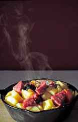 fried food with smoke in a pan