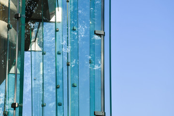 Frameless glass facade modern building, tempered laminated glass wall or curtain wall blue color, Modern architecture material