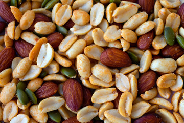 Background made of peanuts, almond, pumpkin seeds top view