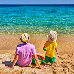 Toddler boy on beach with father