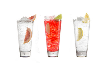 A variety of alcoholic drinks, beverages and cocktails on a white background. Three different drinks with a decoration of citrus.