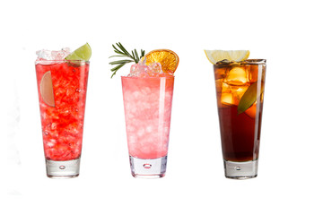 A variety of alcoholic drinks, beverages and cocktails on a white background. Three refreshing drinks in glass goblets.