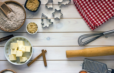 Culinary background with ingredients for baking. Oatmeal, sugar, eggs, butter, cinnamon sticks,...