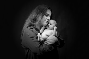 Mother kissing her newborn baby after breastfeeding - Image