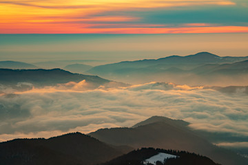 Mountain landscape with winter fog at sunse of Ceahlau, Romaniat