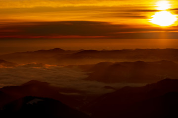 Mountain landscape with winter fog at sunse of Ceahlau, Romaniat