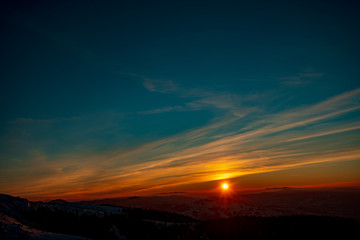 Mountain landscape with winter fog at sunse of Ceahlau, Romaniat