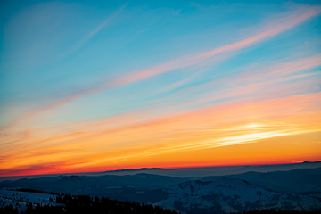 Mountain landscape with winter fog at sunse of Ceahlau, Romaniat