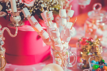 Candy Bar. Dessert table for a party. Marshmallow skewers