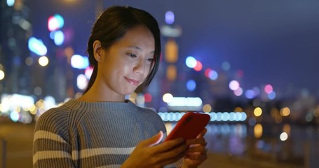 Woman use of mobile phone at night