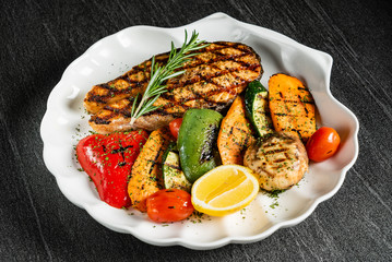 Grilled salmon steak with grilled vegetables and red wine