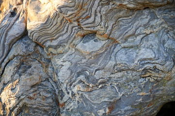 pattern in stone left by erosion over time at the beach