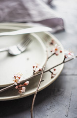 Spring table setting with blooming tree branch