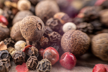 Peas, pepper mix, allspice close-up on wooden background