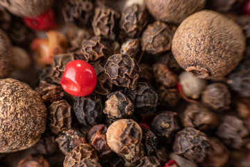 Peas, pepper mix, allspice close-up on wooden background