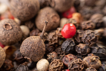 Peas, pepper mix, allspice close-up on wooden background