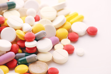 Different colorful tablets at white background	