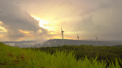 Wind mill turbine generator in the sunset.