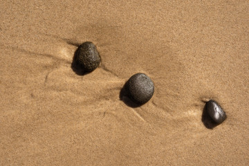 Fototapeta na wymiar Stones Pressed in the sand