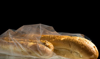Food, packaging, transparent bag with loaf, rolls and bread inside