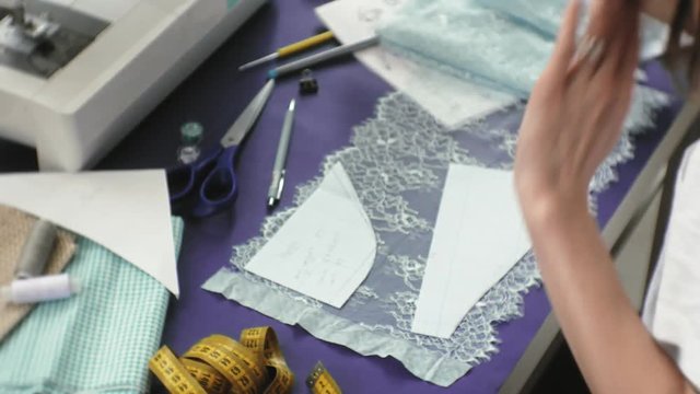 desktop seamstress, designer lingerie, side view, purple background