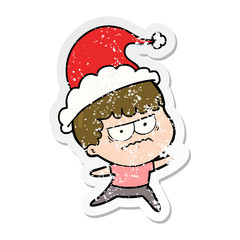 distressed sticker cartoon of a annoyed man wearing santa hat