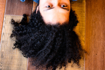 Man with curly hair looking up