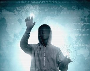 Hacker in black hoodie touching virtual screen with binary code