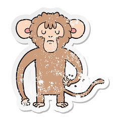distressed sticker of a cartoon monkey scratching