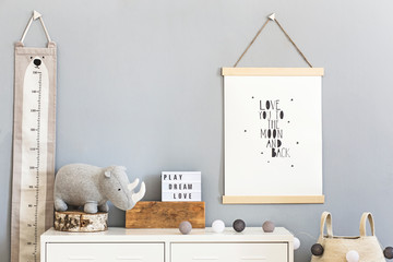 Stylish and cute scandinavian decor of child room with mock up poster, white shelf, natural toys,...