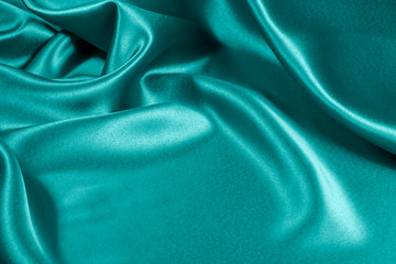 Closeup of rippled light blue satin fabric