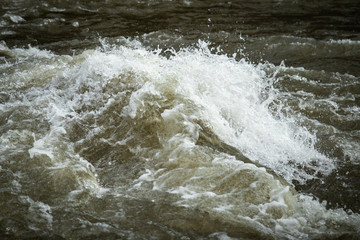 Turbulent water in river swollen due to snow melting