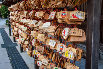 Wooden wishes signs near tempel in Japan with colorful pictures