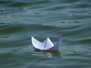 The paper boat floats on the waves. 