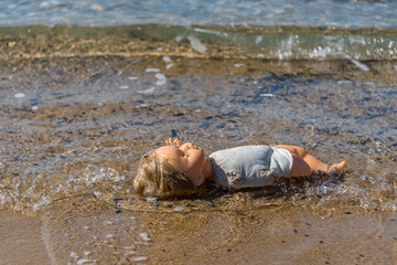 Old Doll Washing Ashore on a Mediterranean Beach