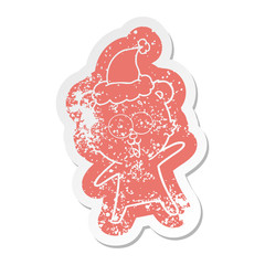 laughing teddy  bear cartoon distressed sticker of a wearing santa hat