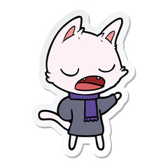 sticker of a talking cat wearing winter clothes